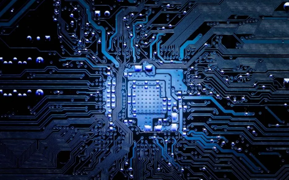 Blue toned PCB macro of chip area and complex circuitry