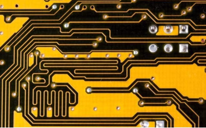 yellow PCB routing featuring serpentine traces for length matching and impedance control on a complex circuit board.