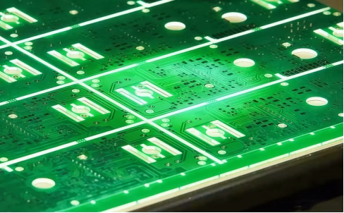 High-speed PCB panel in production showing green dielectric material layers for signal isolation.