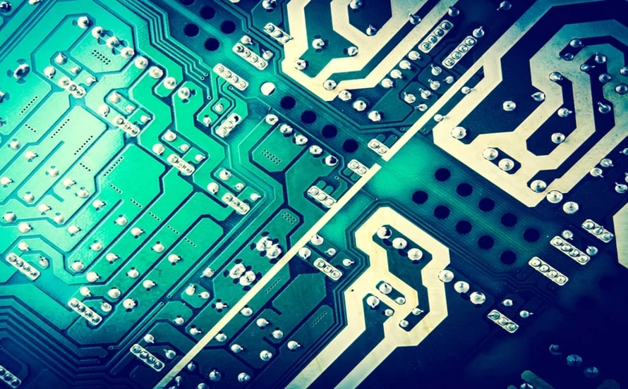 Close-up of high-density SMT printed circuit board integrated with multi-wire harness connector inside metal chassis